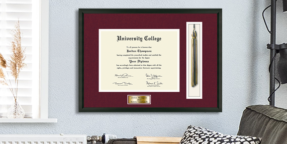 Red diploma frame with tassel hanging on a wall