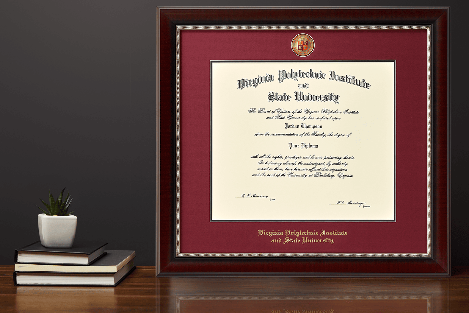 Virginia Tech Diploma Frame with masterpiece medallion on a desk