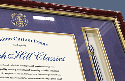 Close up of college diploma frame with tassel