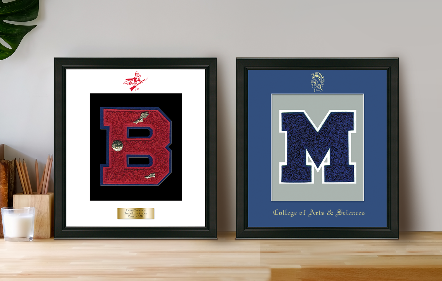 Two varsity letter frames on table
