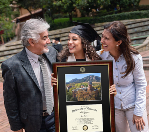 parents with a graduate holding a diploma frame.