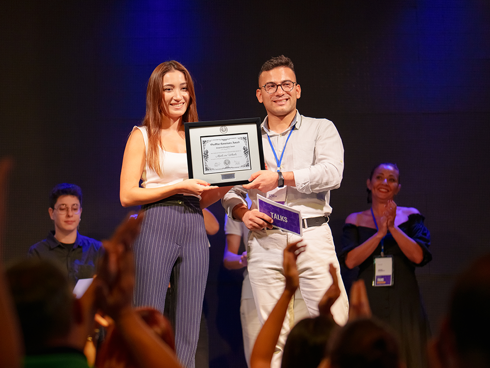 Person being presented certificate during a corporate event