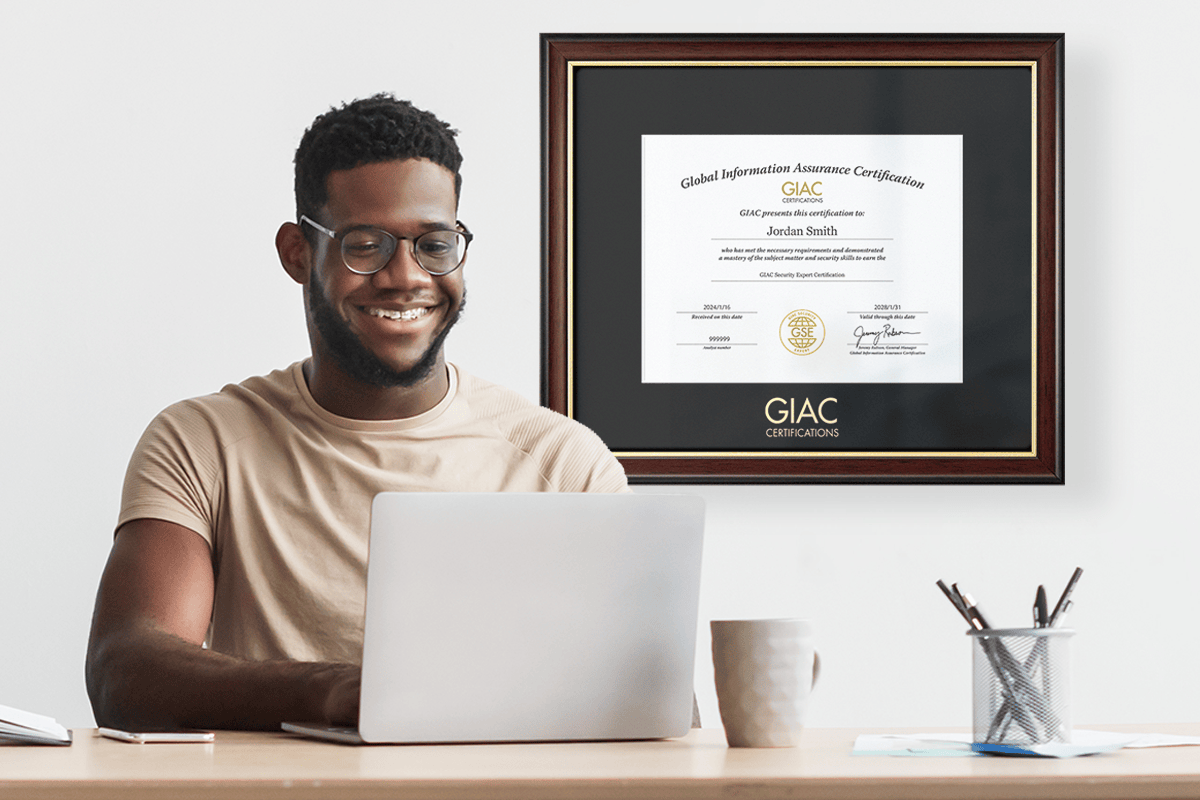 professional at desk with GIAC certificate frame on wall