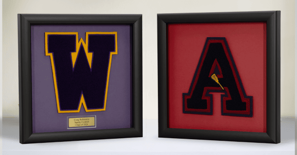 Two varsity letters in a shadow box frame with black moulding.