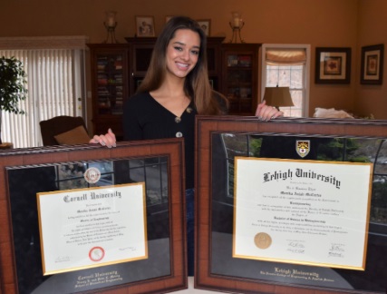 cornell university grad with two diploma frames