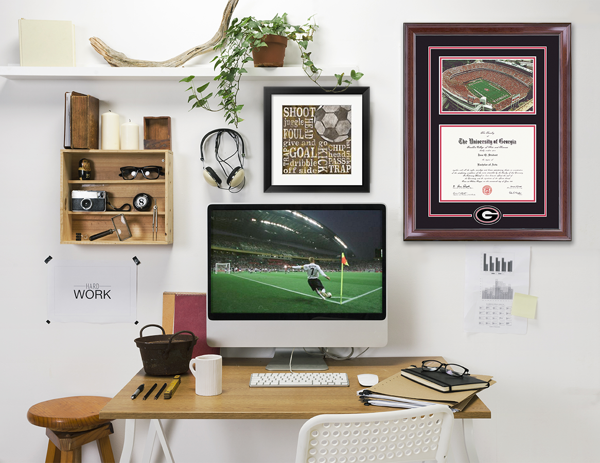 Computer desk with sports game on with George Mason Stadium spirit frame