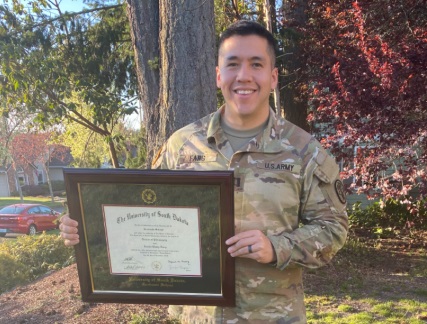 Military graduate holding his custom diploma frame