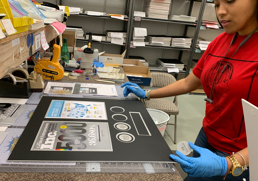 Professional framer handcrafting frame at production facility