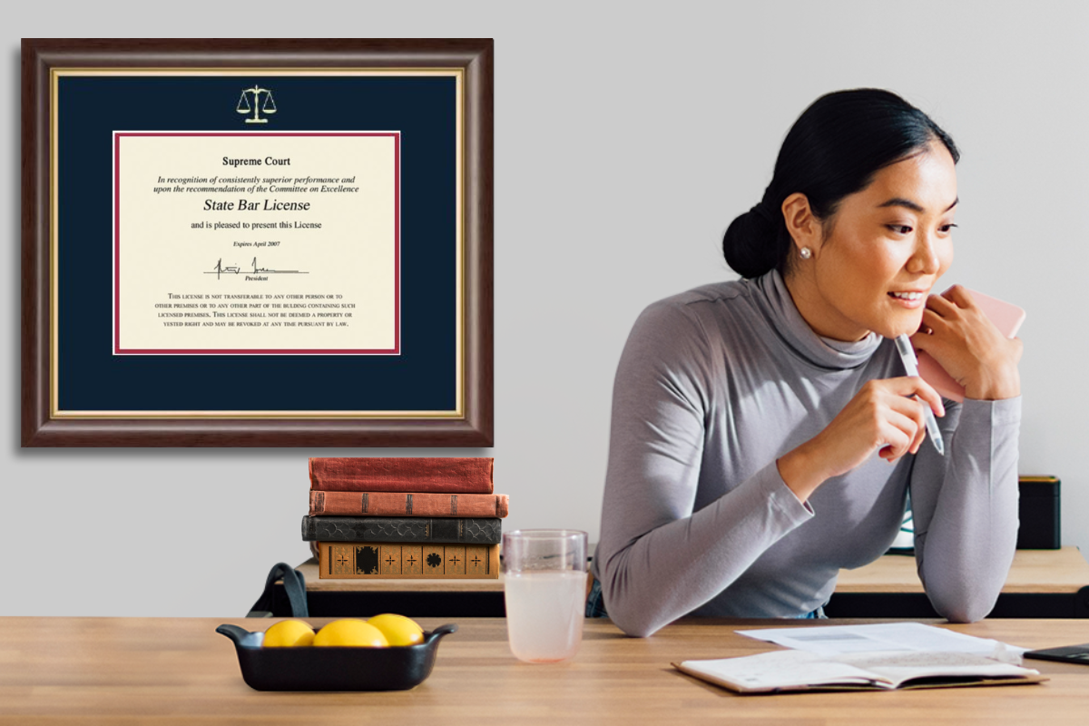 lawyer in office with legal certificate frame on wall