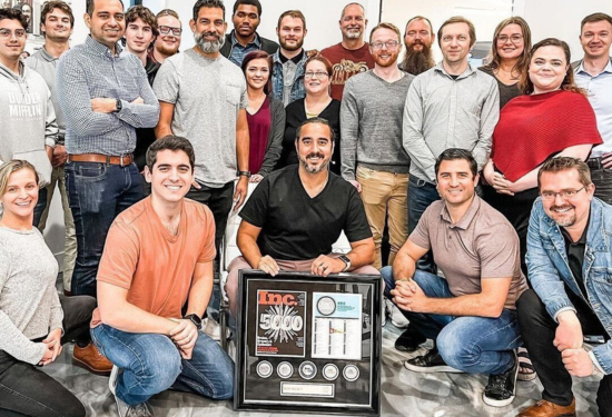 large group of people around custom INC 5000 award frame 