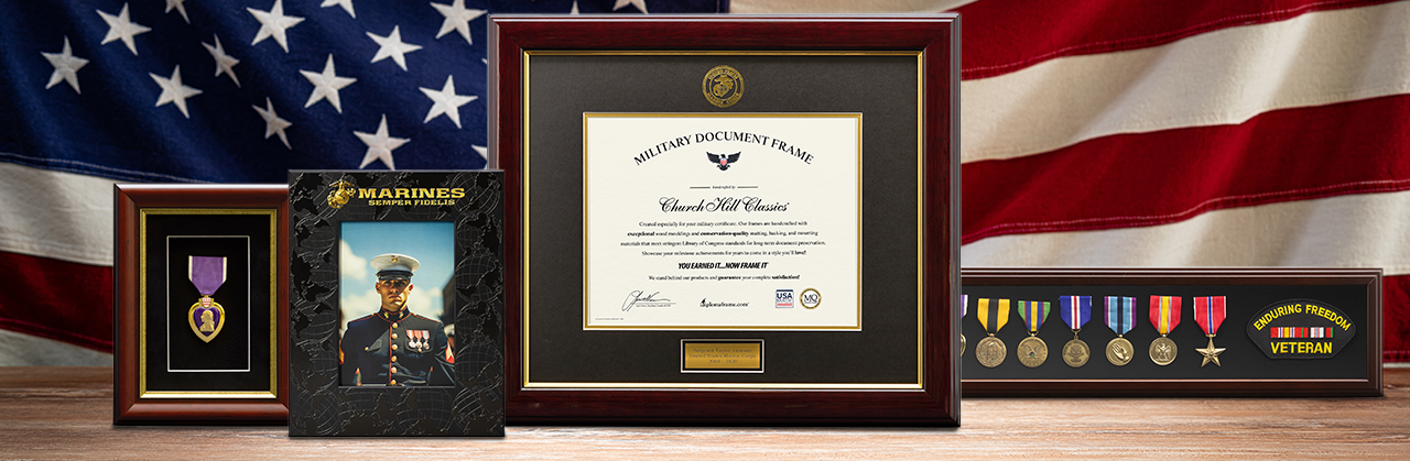 Military frames on a table with American flag in the background