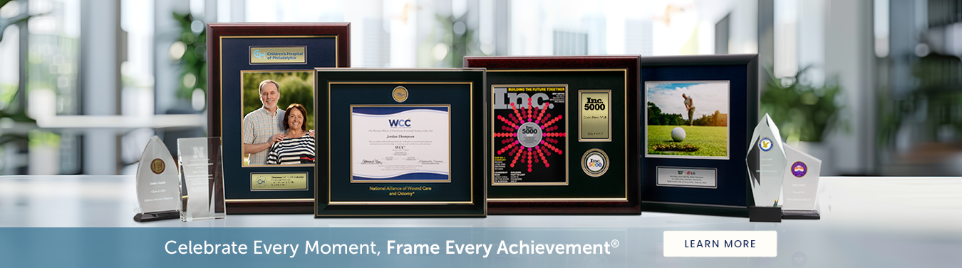 variety of custom frames, plaques, and engraved crystal products with 'Celebrate Every Achievement, Frame Every Moment ®' tagline below frames