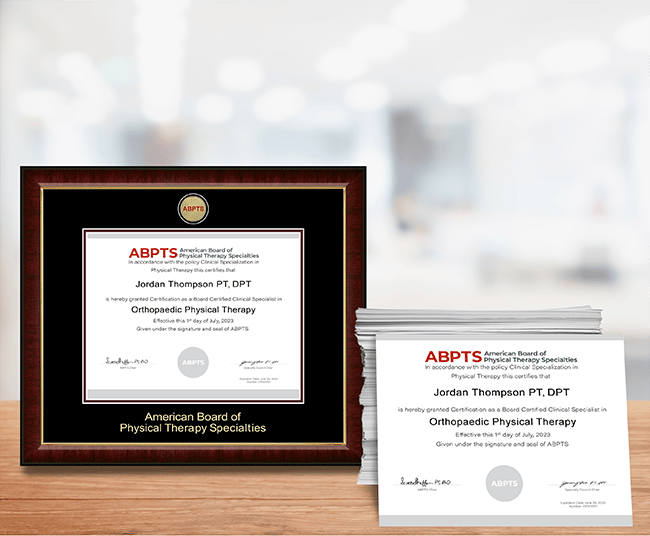 Custom certificate frame and stack of printed certificates on a desk - Print & Frame Solutions