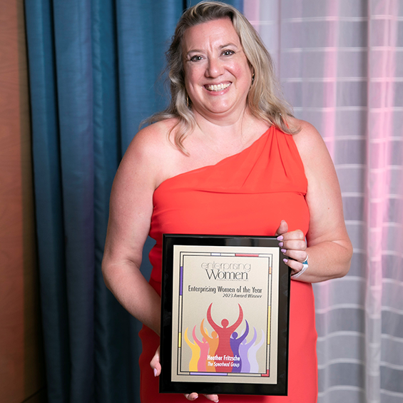 Woman holding a custom Enterprising Women plaque