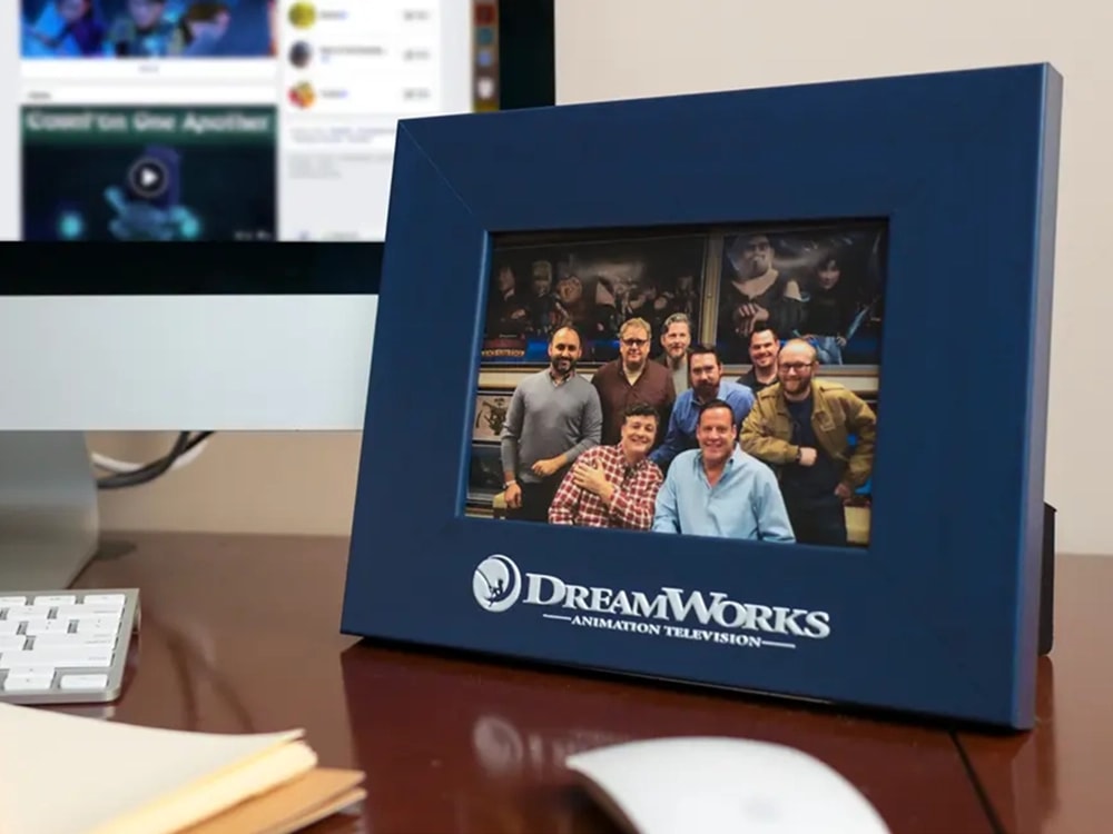 Custom photo frame featuring the DreamWorks logo placed on a desk