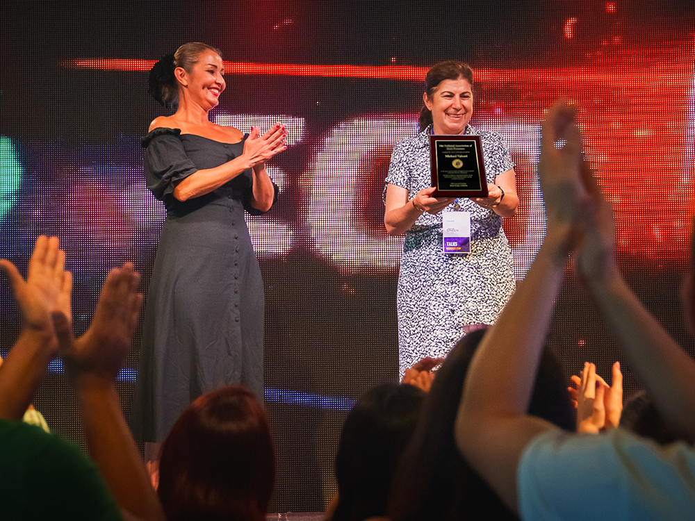 Woman receiving a custom award frame at conference