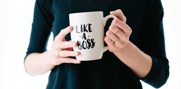 closeup of hands holding like a boss coffee mug