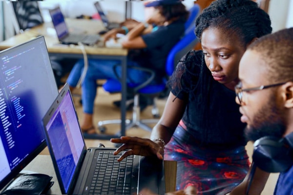 mentor showing employee something on computer