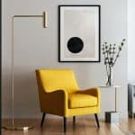 float mounted artwork in living room with yellow chair