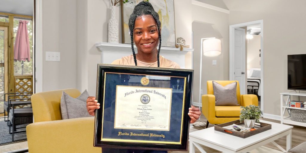 girl holding florida international university frame