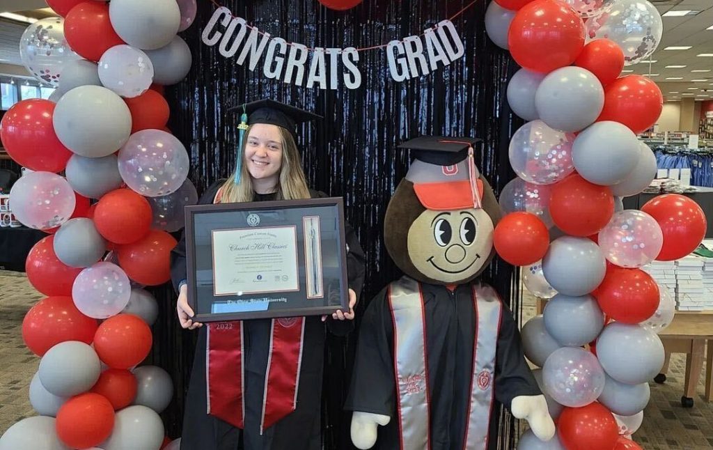 graduate at grad fair holding ohio state diploma frame