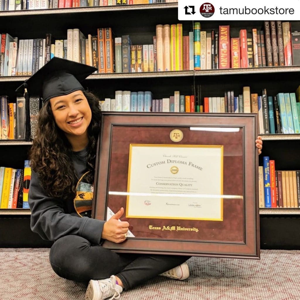 TAMU graduate with diploma frame