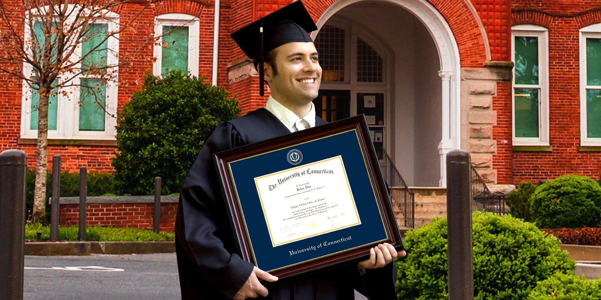 graduate smiling holding uconn diploma frame