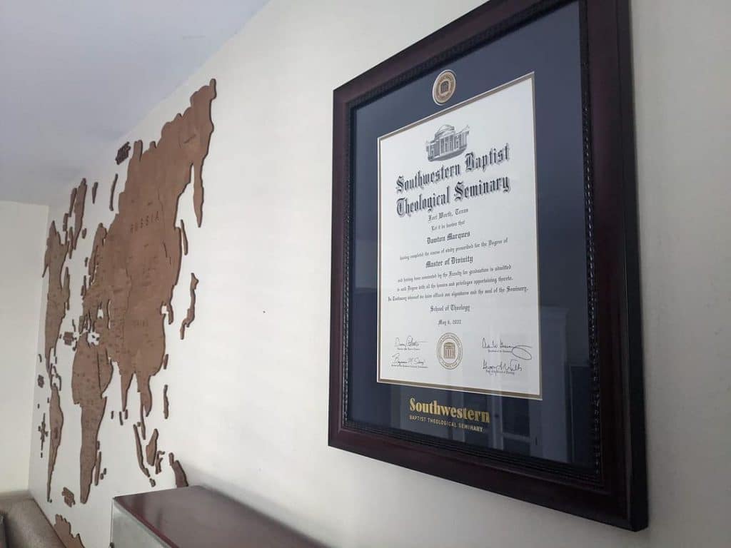 closeup of framed diploma on office wall