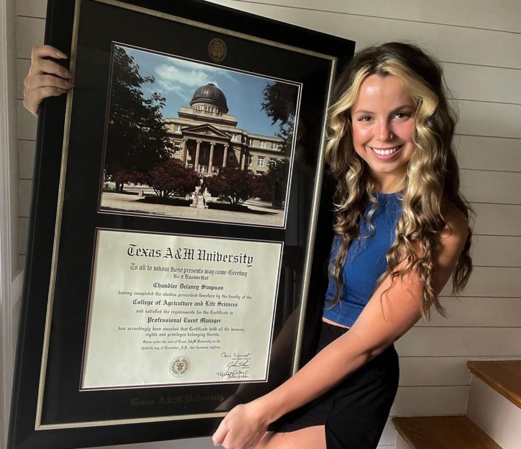 girl holding texas a&m diploma frame