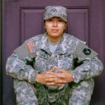 military graduate sitting on doorstep