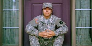 military graduate sitting on doorstep