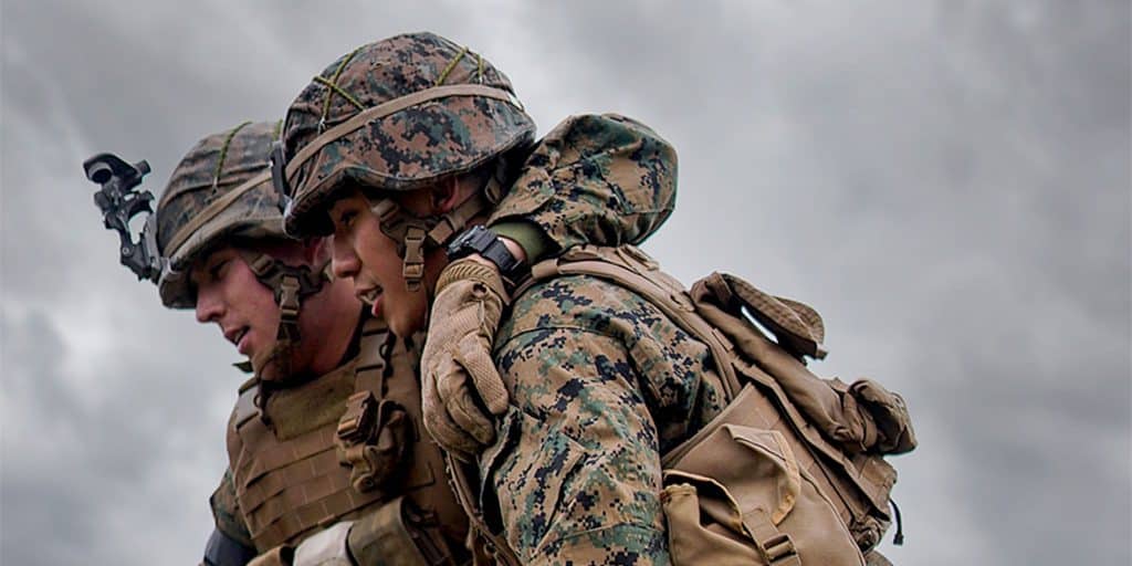 two marines in gear walking together