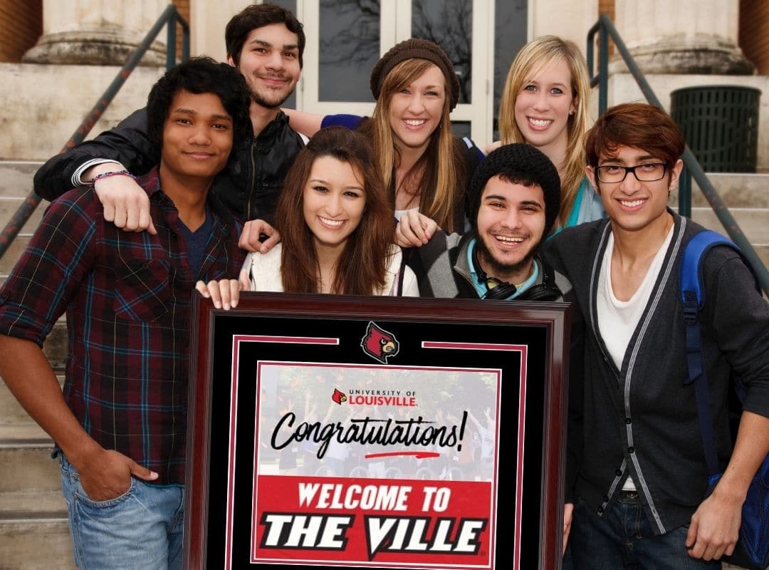 louiville freshmen holding cardinal frame