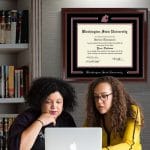 women in office with washington state u diploma frame