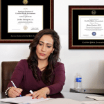 woman in office with professional license frames