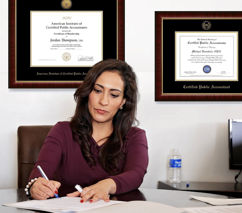woman in office with professional license frames