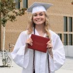 graduating girl with a diploma cover