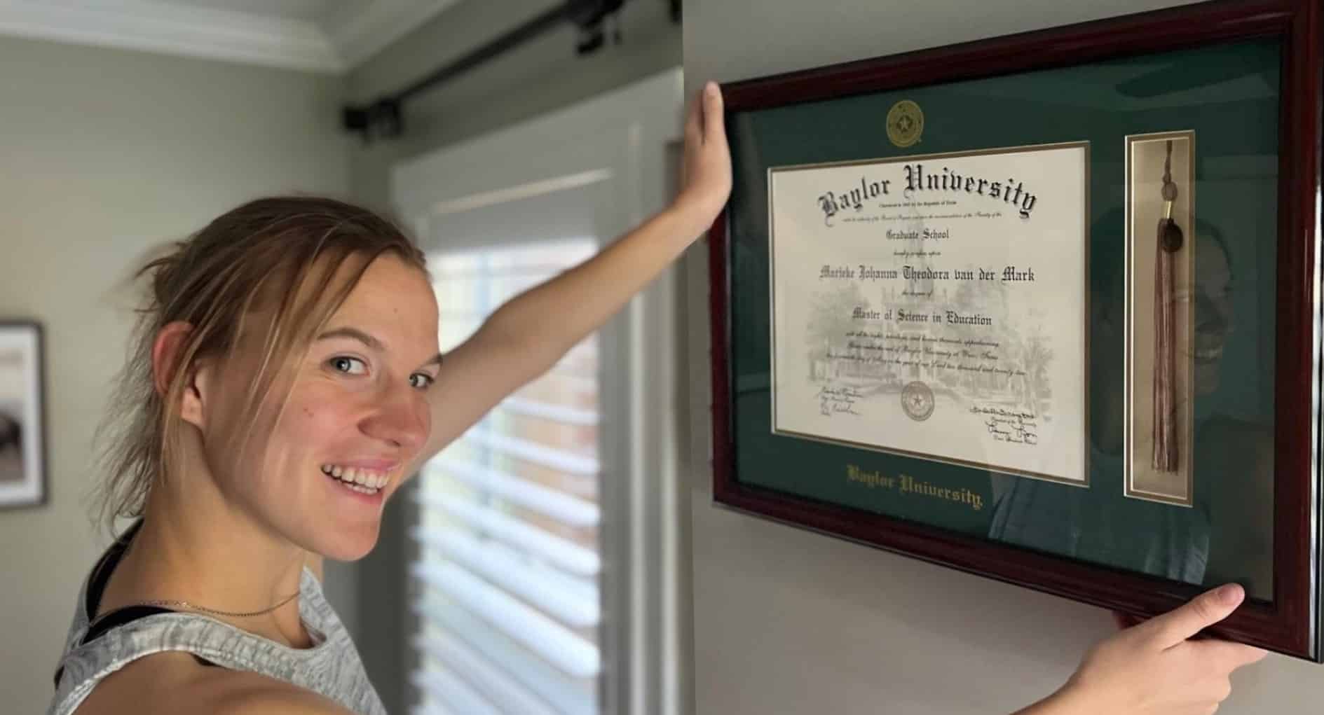 woman hanging baylor diploma frame on wall