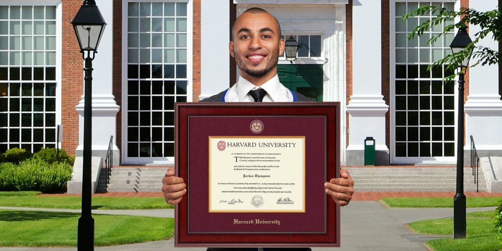 smiling man holding harvard crimson diploma frame on campus