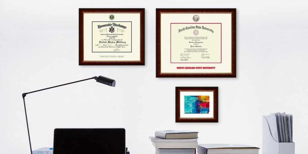 army certificate frame and nc state frame on office wall