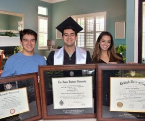 three graduates with their diploma frames