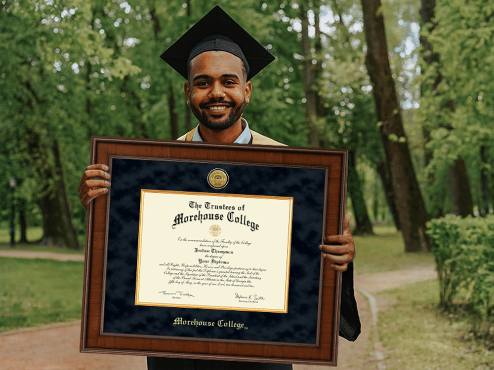 Morehouse grad holding diploma frame