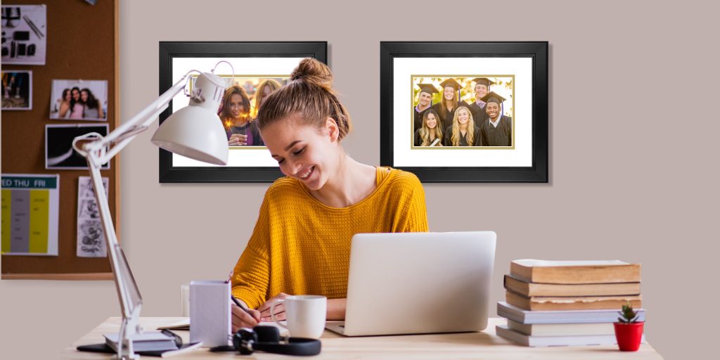 girl studying at her desk with two custom church hill classics photo frames on wall behind her