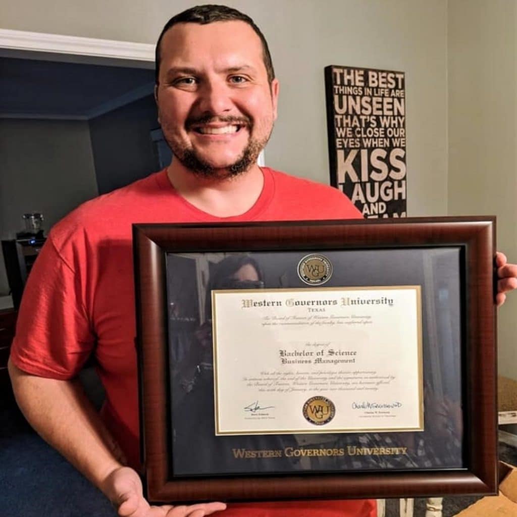 man with his WGU diploma frame