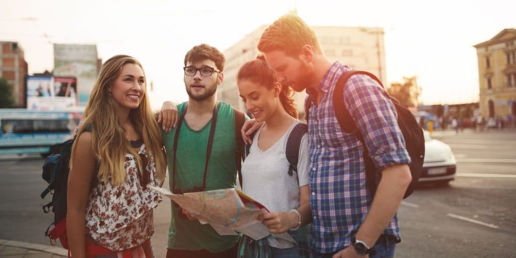 group of young adults looking at map