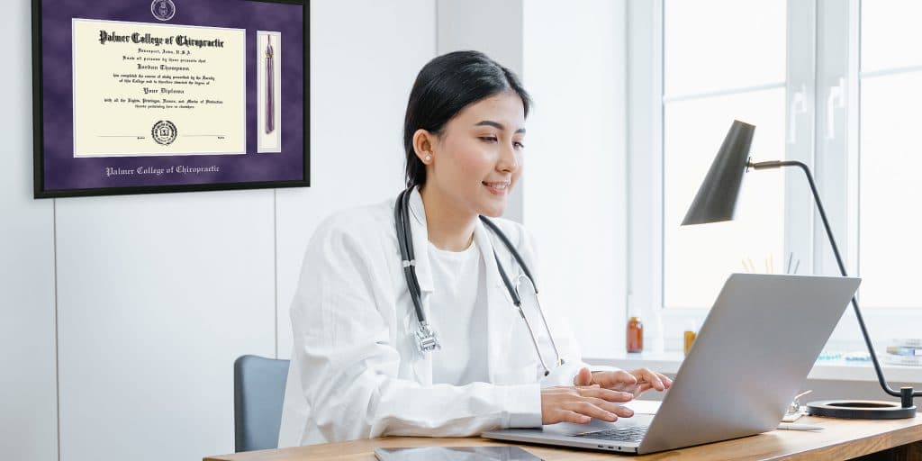 chiropractor typing on laptop in office