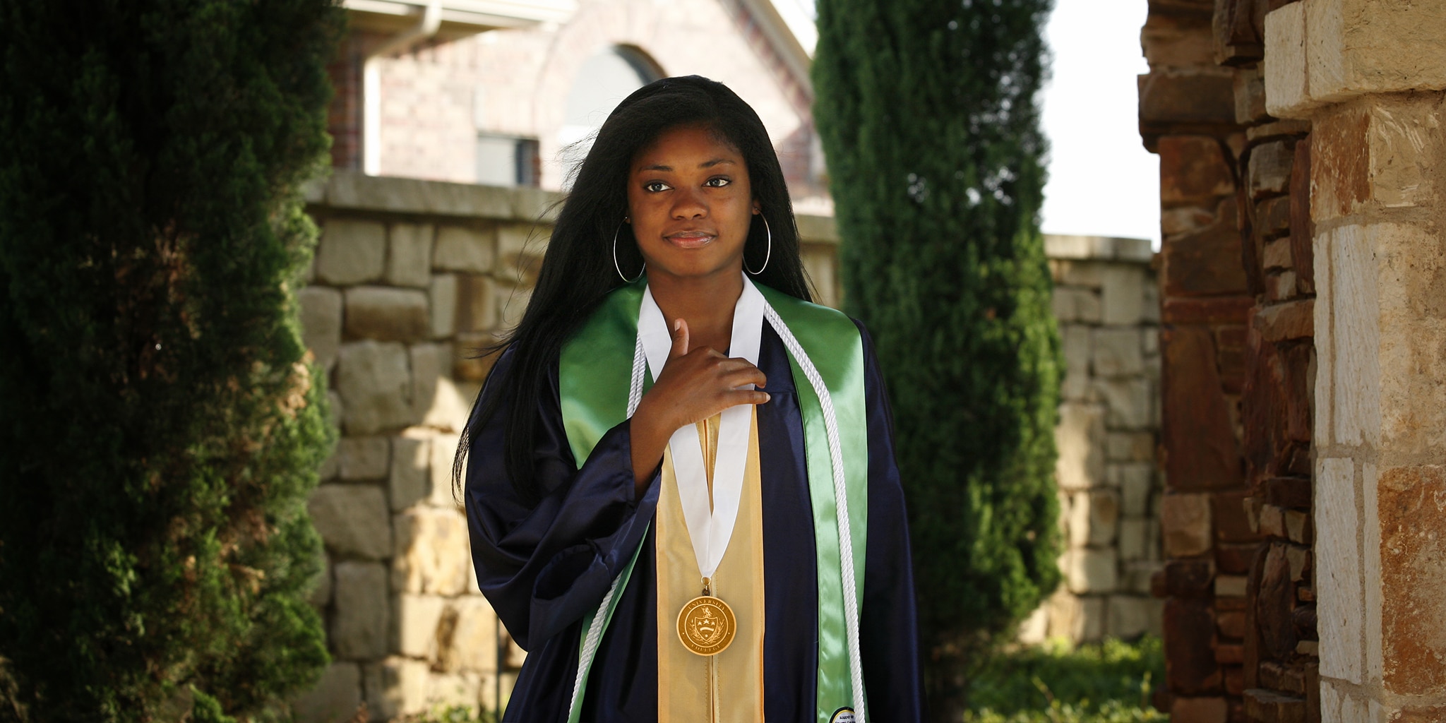 graduate wearing honor medallion and stoles on graduation day