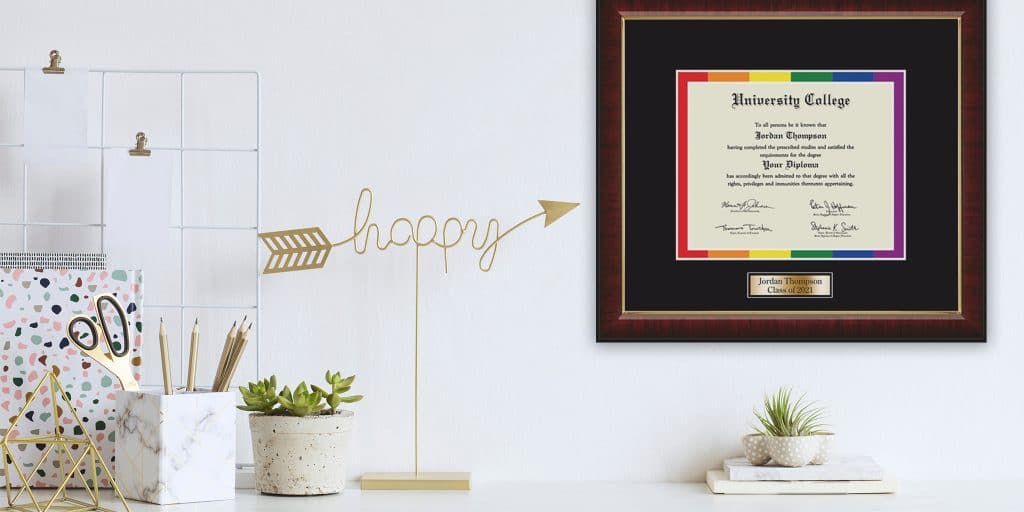 Rainbow pride diploma frame hanging above desk