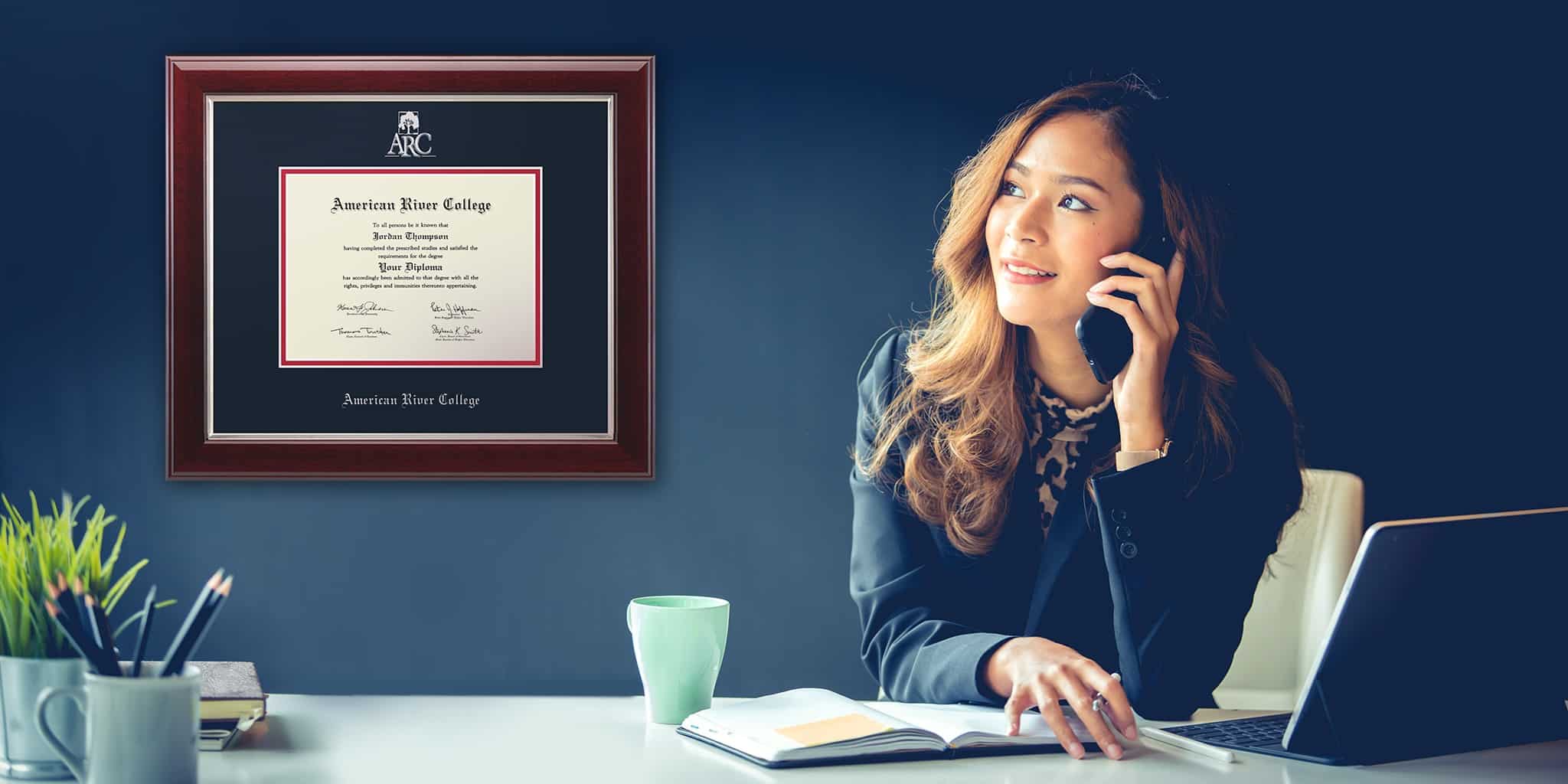 woman in office with American River College frame on wall