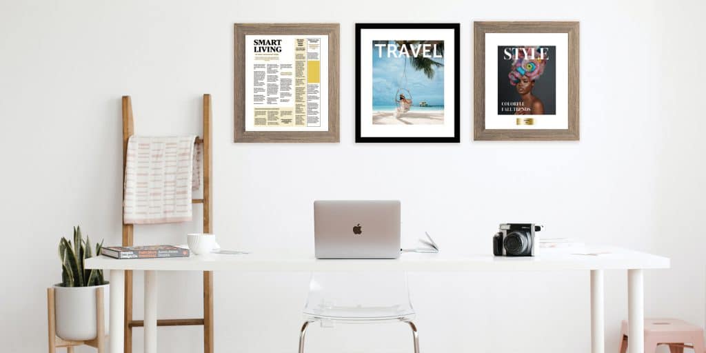 desk in office with three custom magazine cover frames behind